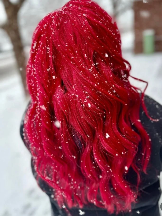 Vivid red hair photographed in the snow by Stephanie Thomas at Gypsy Cosmo Salon